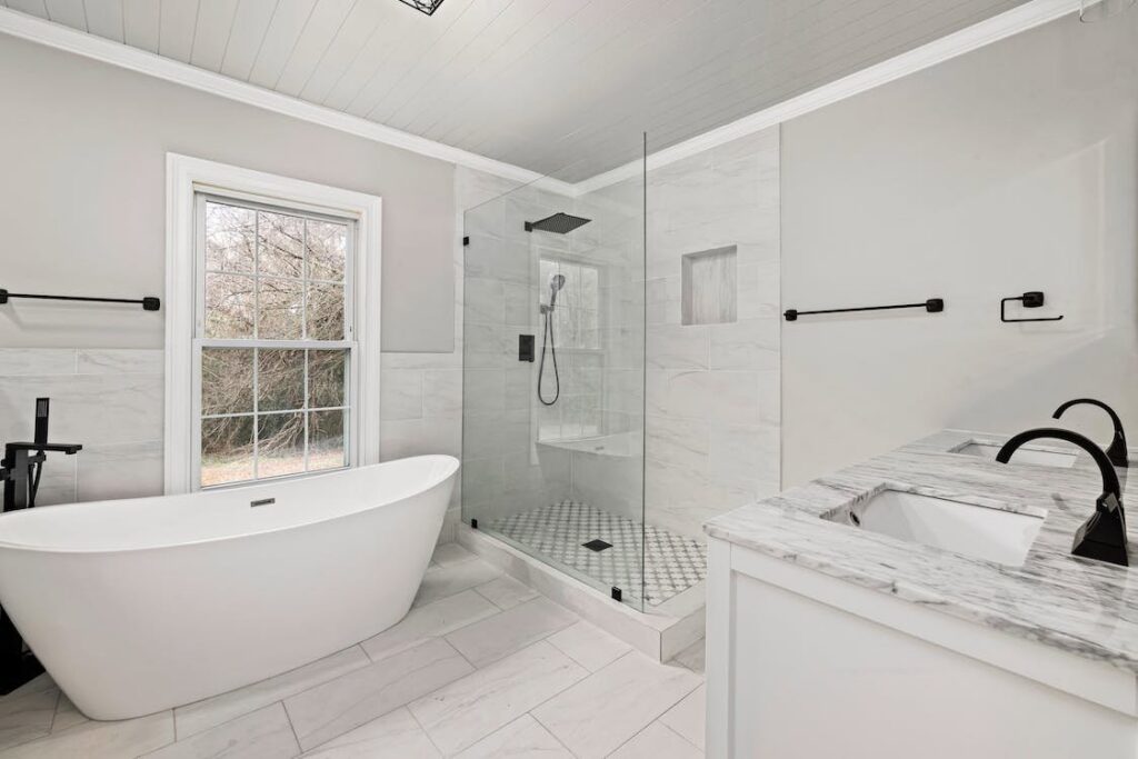 A luxurious bathroom renovation with a freestanding tub and glass shower by Orival Property Services in Boston, MA.