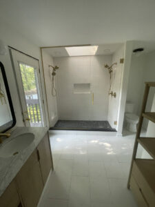 A luxurious bathroom renovation with a walk-in shower and elegant gold fixtures by 3Rivers General Contracting in Pittsburgh, PA.