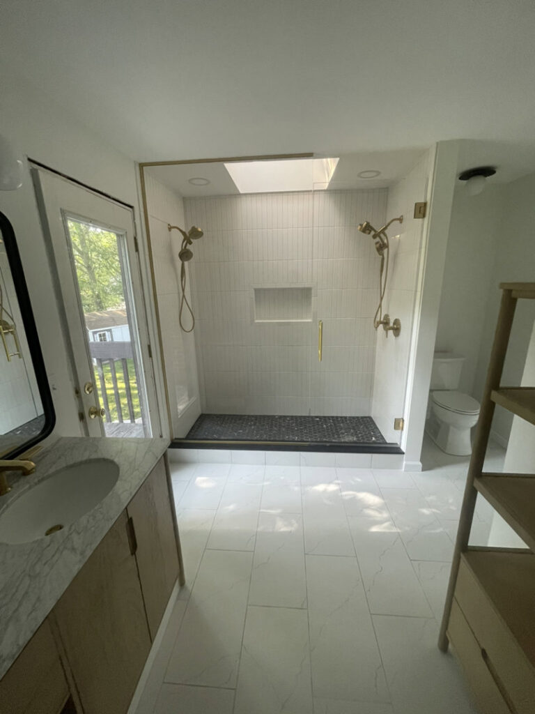 A luxurious bathroom renovation with a walk-in shower and elegant gold fixtures by 3Rivers General Contracting in Pittsburgh, PA.