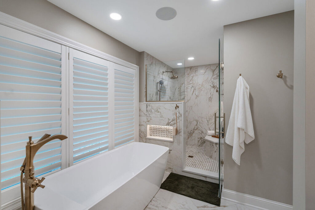 A luxurious bathroom renovation with a freestanding tub and walk-in shower by J Brothers Design- Build- Remodel, Inc. in Corcoran, MN