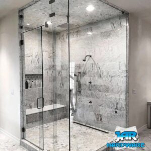 A luxurious bathroom featuring a large glass shower enclosure and marble-look tiles by Jar Hardware in Hialeah, FL.