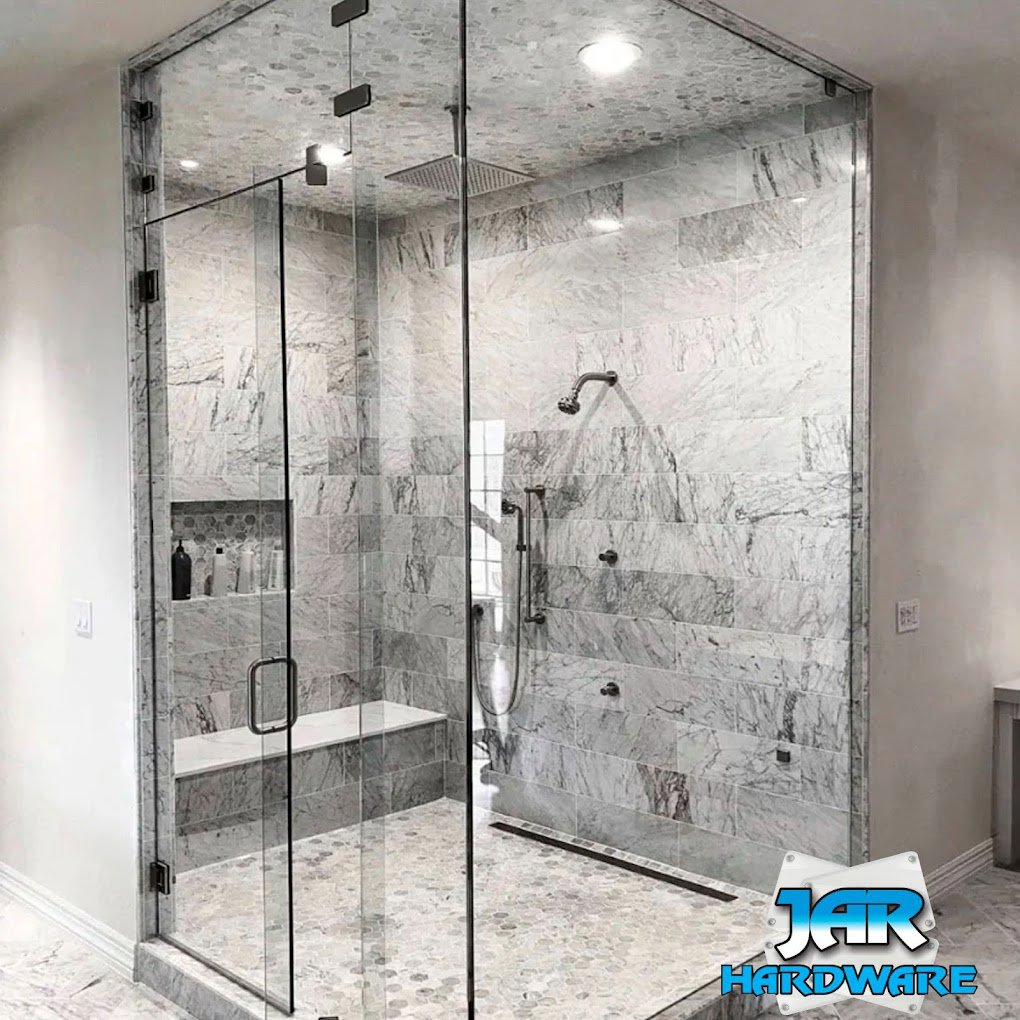 A luxurious bathroom featuring a large glass shower enclosure and marble-look tiles by Jar Hardware in Hialeah, FL.