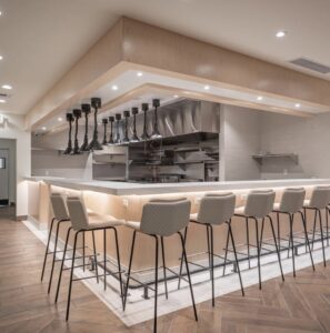 A luxurious walk-in shower with elegant stone walls installed by Oddonetto Granite & Marble LLC in Phoenix, AZ.