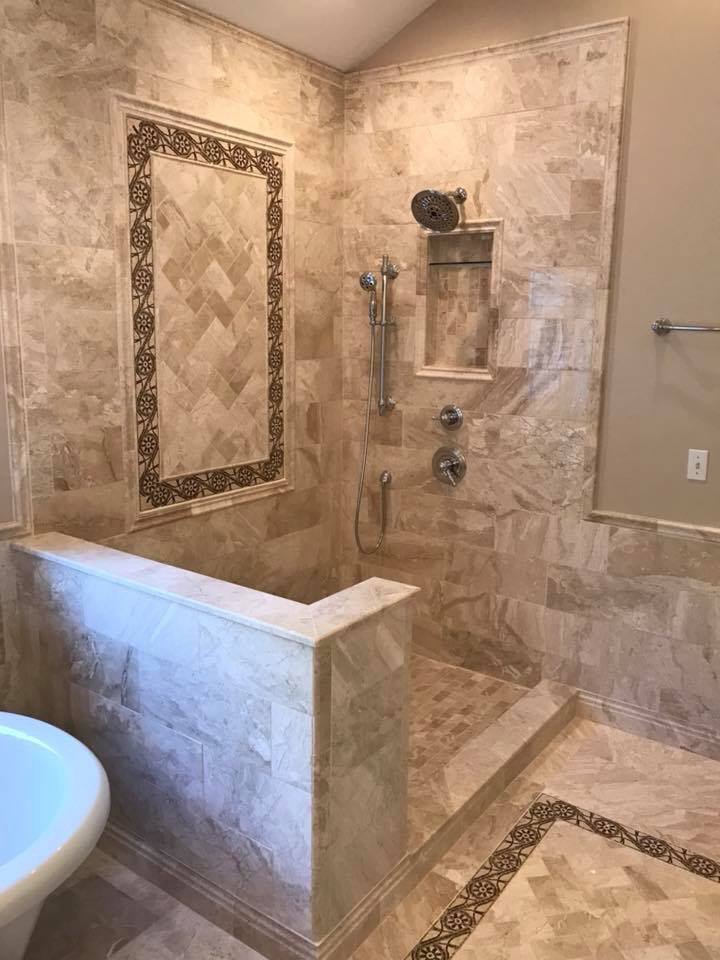 A luxurious walk-in shower with intricate tile work and multiple shower heads installed by Pro Remodel LLC in St. Charles, MO.