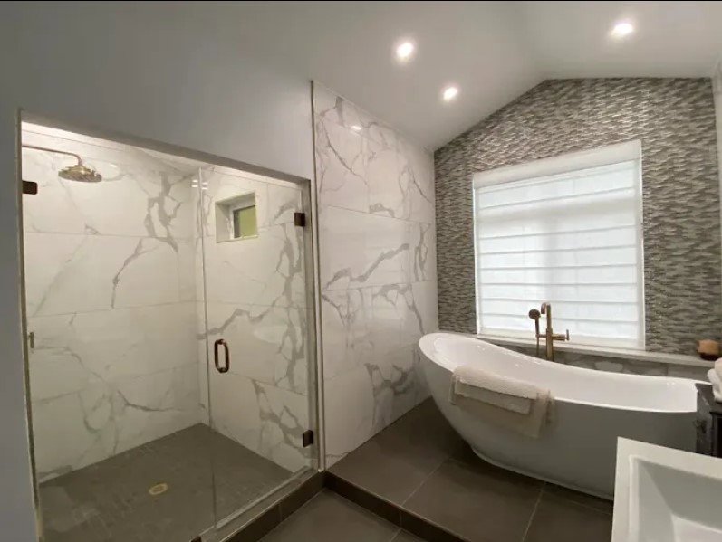 A luxurious bathroom remodel featuring a walk-in shower and freestanding tub by Nextek Construction Service LLC in Taylor Mill, KY.