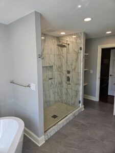 A luxury bathroom remodel with a walk-in shower and freestanding tub by Antalek Construction LLC in Erie, PA