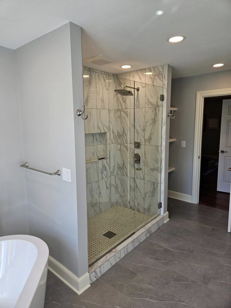 A luxury bathroom remodel with a walk-in shower and freestanding tub by Antalek Construction LLC in Erie, PA