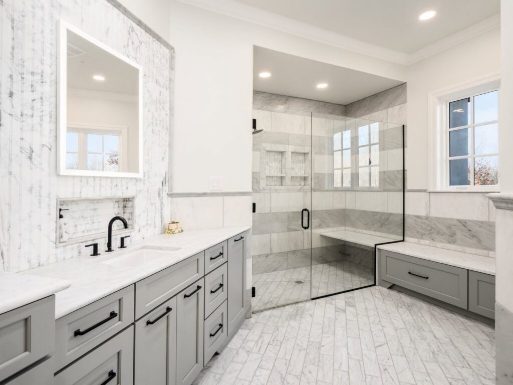 A luxurious bathroom remodel featuring a large walk-in shower and double vanity by Saunders Dynamic Remodeling in Columbus, OH