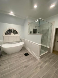 A luxurious bathroom renovation featuring a freestanding tub and glass shower by Strom Contracting LLC in Crystal Lake, IL.