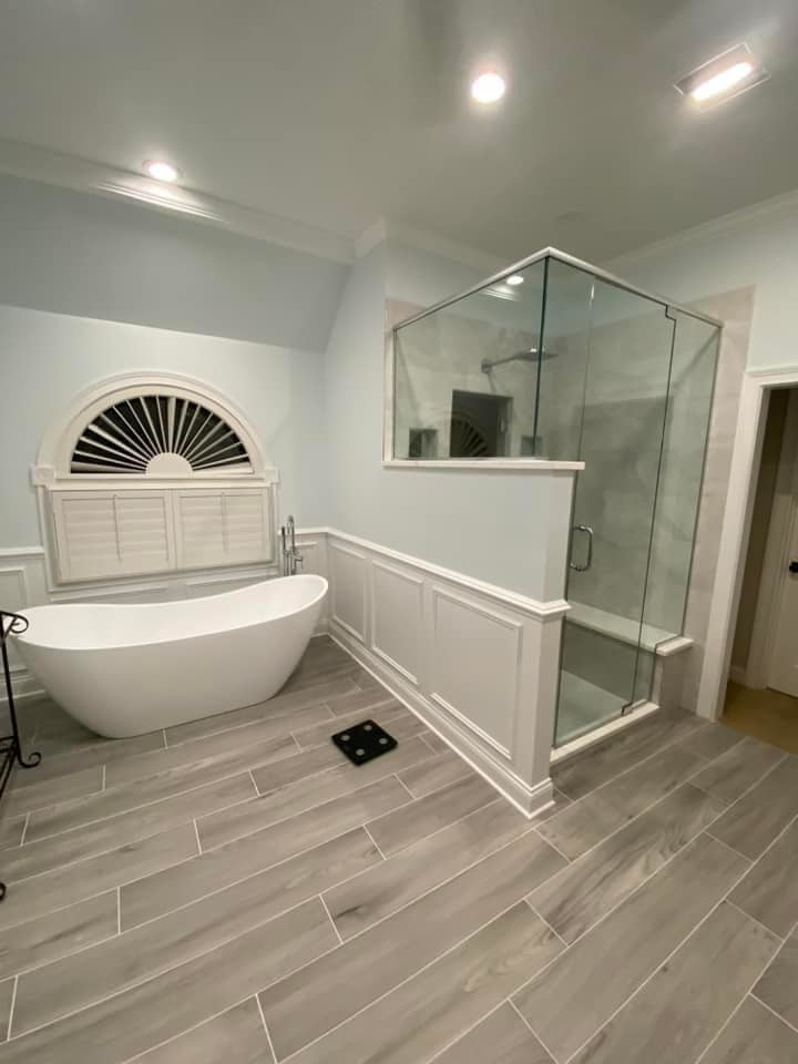 A luxurious bathroom renovation featuring a freestanding tub and glass shower by Strom Contracting LLC in Crystal Lake, IL.