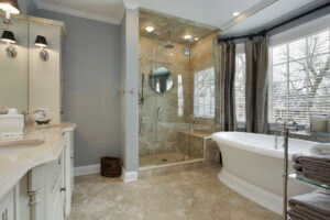 A luxurious bathroom renovation featuring a large glass shower and freestanding tub by Pro Renovations Savannah, GA.