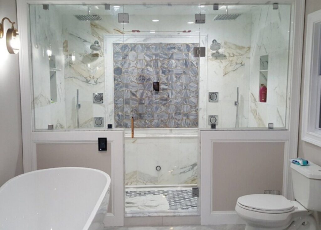 A luxurious bathroom renovation featuring a large walk-in shower and freestanding tub by Garbatini Contracting in Wallingford, CT.