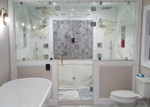 A luxurious bathroom renovation featuring a large walk-in shower and freestanding tub by Garbatini Contracting in Wallingford, CT.