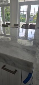 A luxurious room with a grand piano and highly polished floors, a completed project by Cornerstone Services Management in Miami, FL.