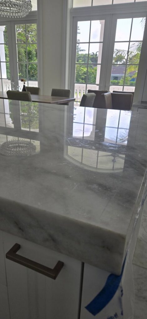 A luxurious room with a grand piano and highly polished floors, a completed project by Cornerstone Services Management in Miami, FL.