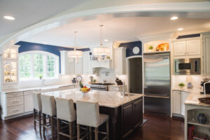 A luxurious kitchen featuring white cabinetry, a large island, and granite countertops by Corrado Custom Homes, Inc. in Kutztown, PA