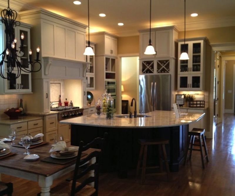 A luxurious kitchen remodel featuring a large island, custom cabinetry, and elegant lighting by Boisen Remodeling LLC in Appleton, WI.