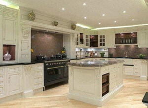 A luxurious kitchen remodel with custom cream cabinetry and a large island by Chicago Service Source Inc in Chicago, IL