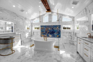 A luxurious master bathroom renovation with marble tiling, a freestanding tub, and a spacious walk-in shower by Bob Build's WNY in Buffalo, NY.