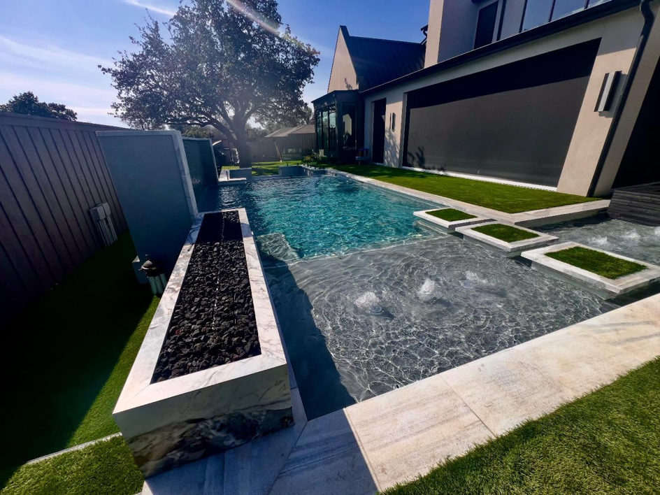 Luxury pool and fire pit design integrated with a home by First Class Pools & Spas in Sachse, TX.