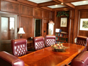 A luxurious wood-paneled office with a large conference table, completed by Symphonic Painting in Oshkosh, WI.