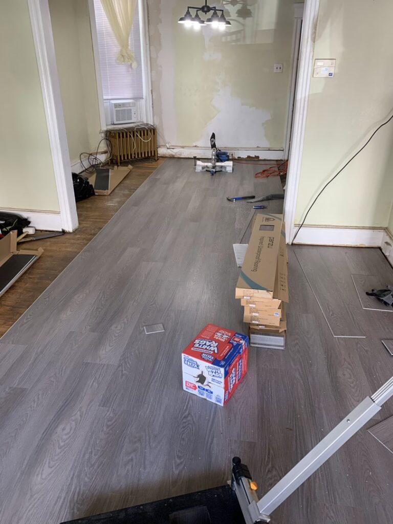LVP or laminate floor installation site with materials and tools by Just Floor It Hardwood Floors LLC in Philadelphia, PA
