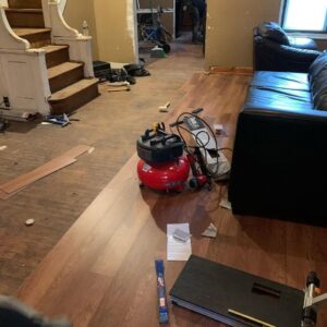 LVP or laminate flooring installation in progress with tools by Just Floor It Hardwood Floors LLC in Philadelphia, PA