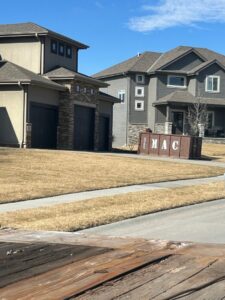A MAC Containers, Inc dumpster delivered to a residential area for junk removal in Omaha, NE.