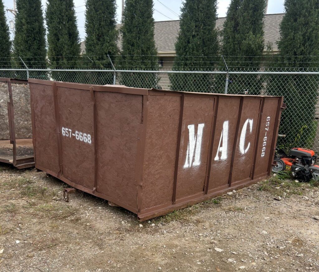 A MAC Containers, Inc dumpster placed on a property for junk removal services in Omaha, NE.