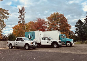 A fleet of Maine Labpack, Inc. vehicles, including trucks and pickups, ready for junk removal services in South Portland, ME.