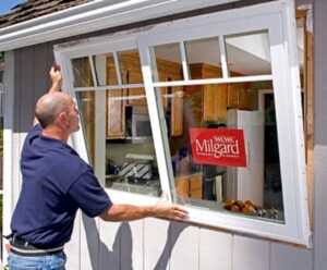 A handyman installing a new window in a home, a service offered by Pocatello Handyman in Pocatello, ID