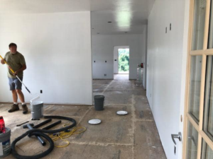 A handyman painting an interior wall during a home renovation project by B & L Builders in Jonesborough, TN