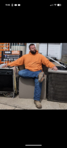 A man sitting among old appliances ready for removal by Rubbish Boyz Removal LLC in Independence, MO.