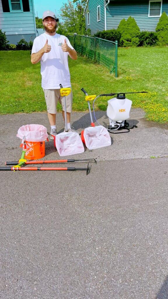 A man giving a thumbs up next to poop scooping tools for Poofect Lawns in Syracuse, NY