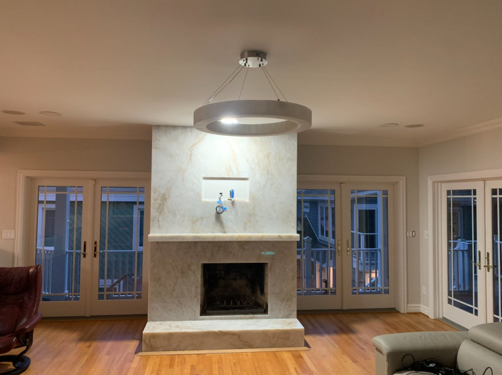 A newly installed marble fireplace surround and mantel by Dream Stone Countertops in Norfolk, VA