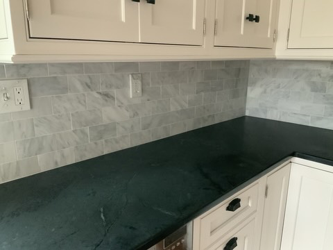 Close-up of a newly installed marble subway tile backsplash and countertop by Balance Painting & Remodeling, LLC in Portland, OR.