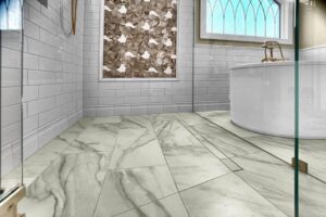 A luxurious bathroom floor with marble-look tiles, a freestanding tub, and a glass shower enclosure by Kore Construction LLC in Cincinnati, OH.