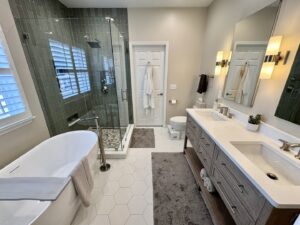 Master bathroom remodel with a freestanding tub, glass shower, and double vanity by Prestige Remodeling Solutions in Jackson, TN.