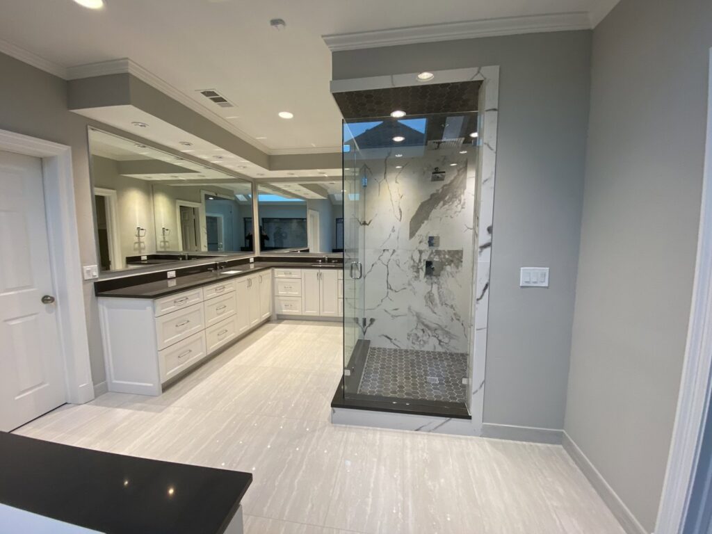 A spacious master bathroom remodel with dual vanity and a large walk-in shower by Home Platinum Services, LLC in Plano, TX