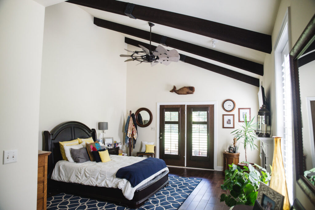 A spacious master bedroom with a vaulted ceiling and exposed beams by Corrado Custom Homes, Inc. in Kutztown, PA