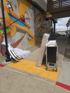 A mattress and other items placed on a sidewalk for junk removal service by Titan Junk Co. in San Diego, CA