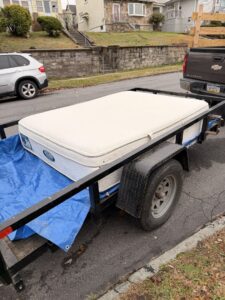 A mattress loaded onto a trailer for removal by Just Junk It in Lancaster, PA.