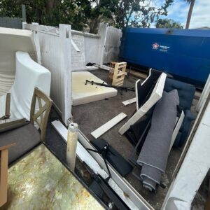 Mattresses, furniture, and debris piled next to a dumpster for junk removal by Veterans Easy Trash: Atlanta in Atlanta, GA.