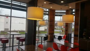 A modern McDonald's dining area interior with large windows by GCM, INC. in Mount Joy, PA