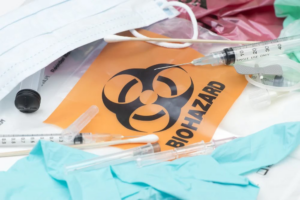 Medical biohazard waste, including syringes and masks, ready for secure disposal by Secure Waste Corp in Orlando, FL.
