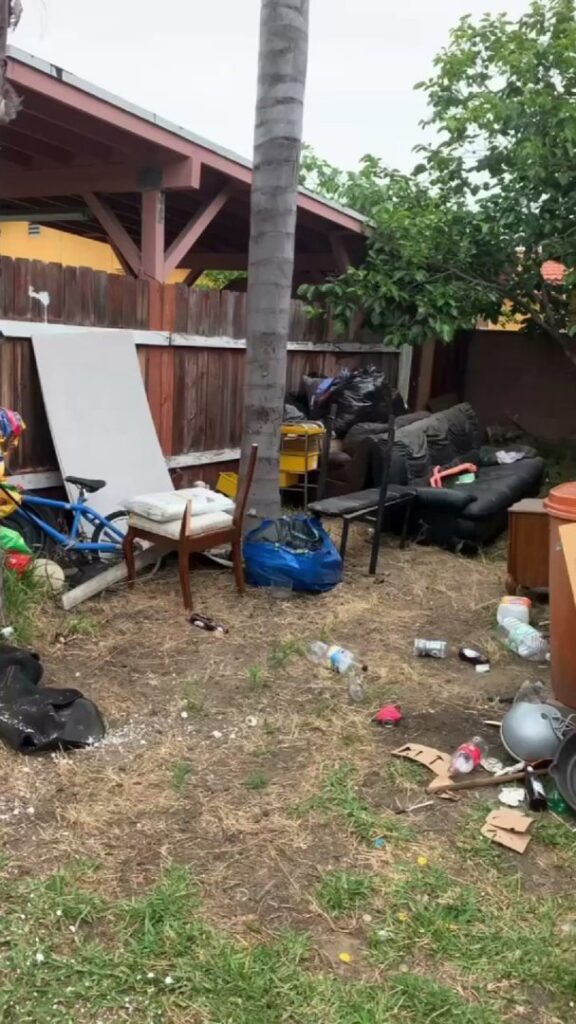 A cluttered and messy backyard filled with various junk items, awaiting general junk removal by We-Haul Junk Removal in Long Beach, CA