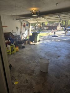 A cluttered garage and driveway filled with various items, ready for junk removal by NTX Haul Away Junk Removal in Fort Worth, TX.