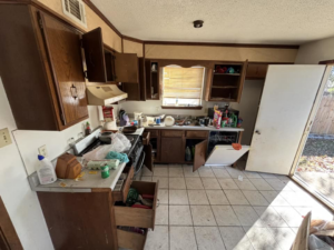 A messy kitchen with open cabinets and debris, showing a space ready for junk removal by Primo Operations in North Little Rock, AR.
