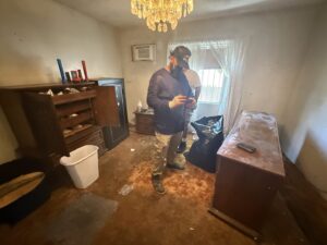 A messy room with furniture, trash bags, and debris on the floor, indicating a space ready for junk removal by L.A. Junk Squad in Bell Gardens, CA.
