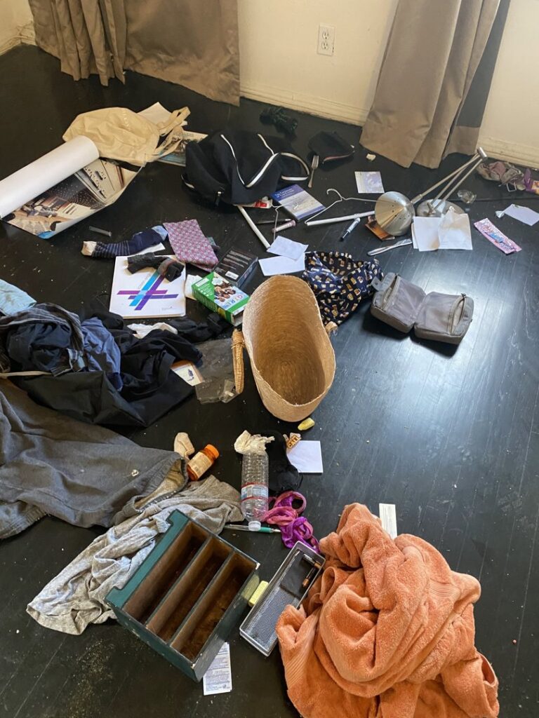 A messy room with various household items on the floor, indicating a cleanout job for West LA Hauling in Los Angeles, CA.